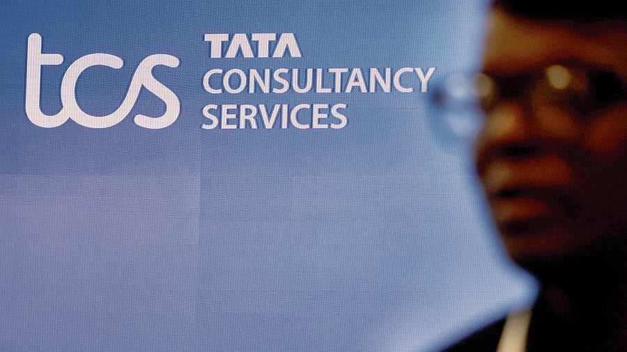 <div class="paragraphs"><p>FILE PHOTO: A man walks past a logo of Tata Consultancy Services (TCS) before a press conference announcing the company's quarterly results in Mumbai, India, January 11, 2024. </p></div>