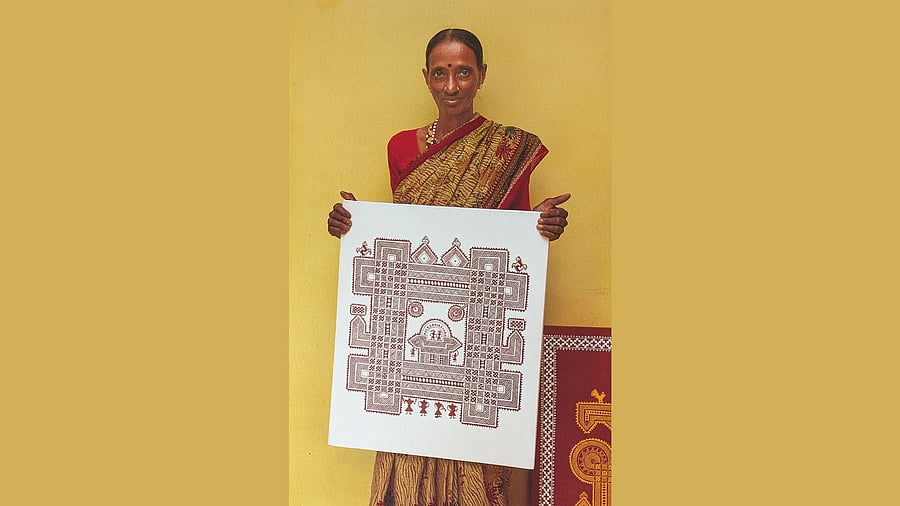 <div class="paragraphs"><p>An artist holding her work. </p></div>
