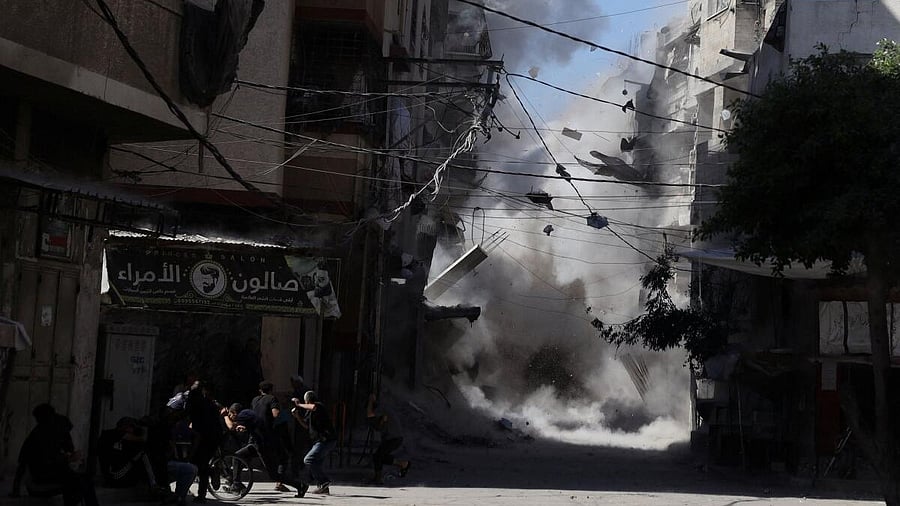 <div class="paragraphs"><p>Palestinians react as an Israeli airstrike hits a house, in Gaza City, September 7, 2025.</p></div>