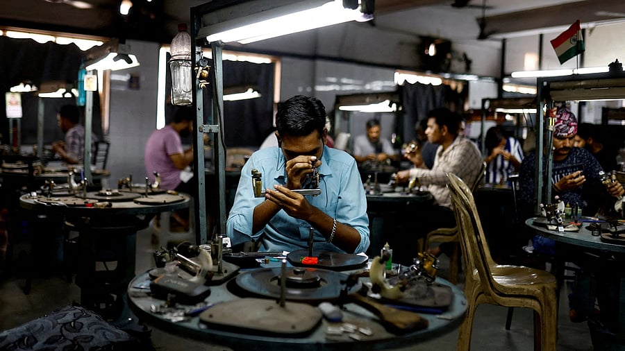 <div class="paragraphs"><p>Craftsmen work on diamonds inside a diamond processing unit in Surat.</p></div>
