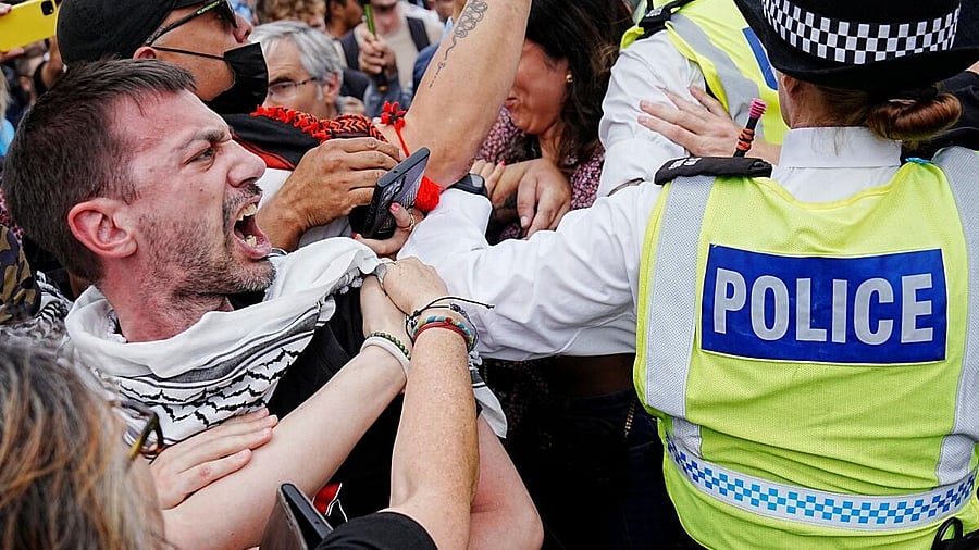 <div class="paragraphs"><p>A man reacts as police officers operate during the "Lift The Ban" rally organised by Defend Our Juries, challenging the British government's proscription of "Palestine Action" under anti-terrorism laws, in Parliament Square, in London, Britain, September 6, 2025.</p></div>