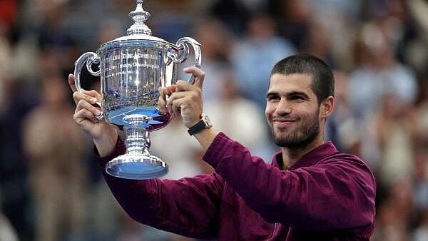 <div class="paragraphs"><p>Spain's Carlos Alcaraz celebrates with the trophy after winning the men's singles final.</p></div>