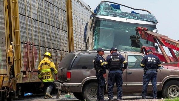 <div class="paragraphs"><p>Authorities work at the scene where a passenger bus was struck by a train while trying to beat it across the tracks, leaving people injured and dead, according to Civil Protection, in Atlacomulco, Mexico.</p></div>