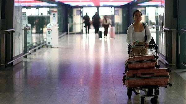 <div class="paragraphs"><p>A passengers walks with her luggage through Heathrow airport in London, Britain</p></div>
