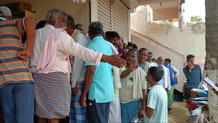 <div class="paragraphs"><p>Representative image of farmers standing in a queue in front of a fertiliser shop.</p></div>
