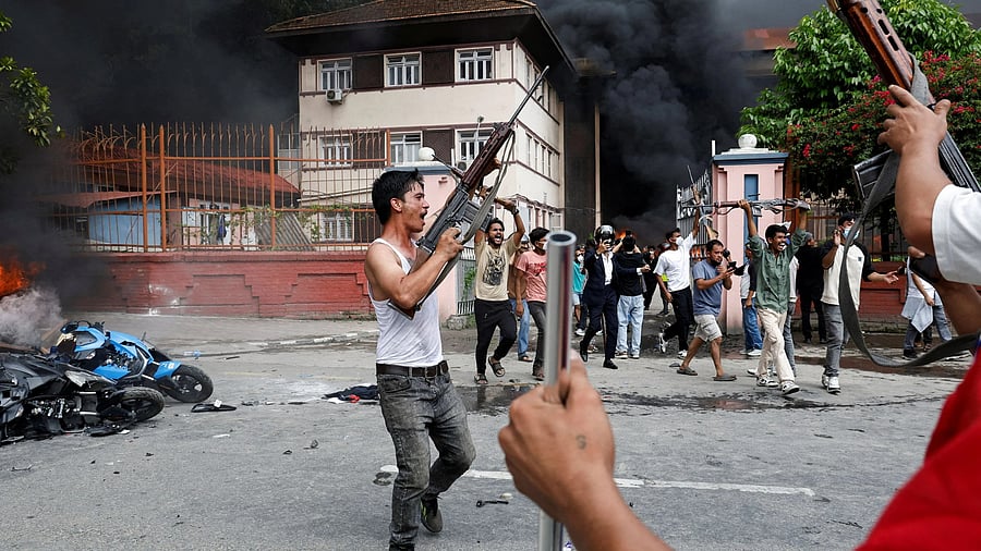 <div class="paragraphs"><p>Demonstrators carrying weapons, taken from the supreme court, take part in a protest against Monday's killing of 19 people after anti-corruption protests that were triggered by a social media ban, outside the supreme court in Kathmandu, Nepal September 9, 2025. </p></div>