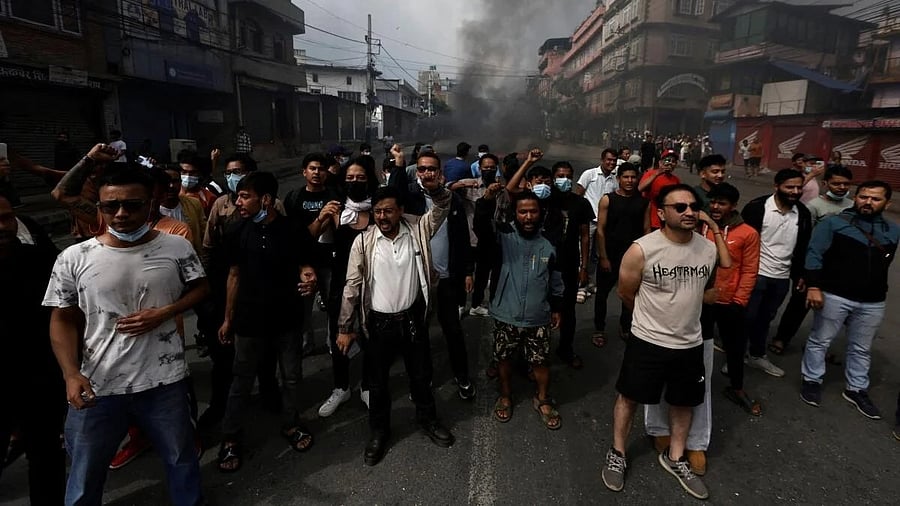 <div class="paragraphs"><p>Demonstrators shout slogans as they gather to protest against Monday's killing of 19 people after anti-corruption protests that were triggered by a social media ban which was later lifted, during a curfew in Kathmandu, Nepal.</p></div>
