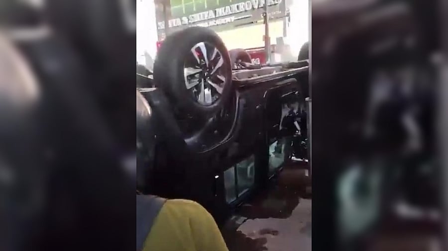 <div class="paragraphs"><p>A Screengrab from a video from X showing the car upside down.</p></div>