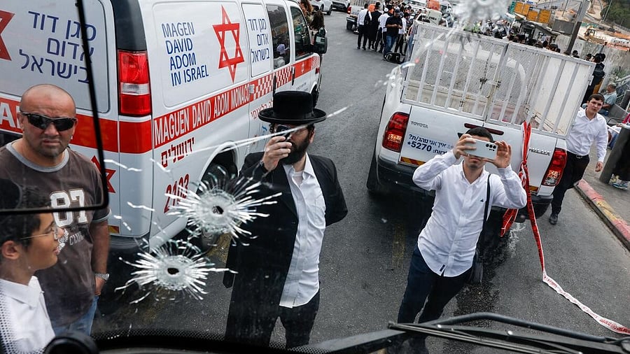 <div class="paragraphs"><p>eople inspect a bus with bullet holes at the scene where a suspected shooting attack took place at the outskirts of Jerusalem.</p></div>