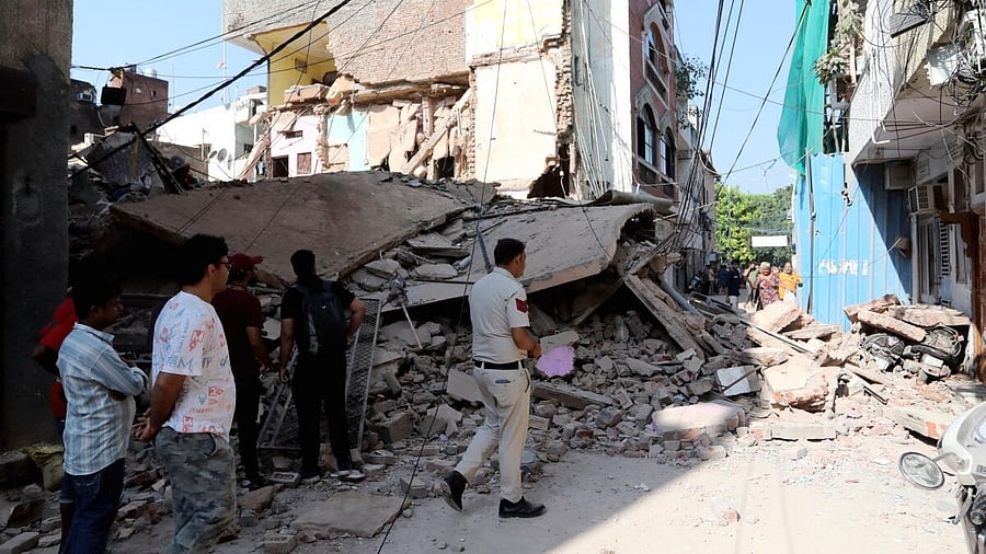 <div class="paragraphs"><p>A police personnel at the site after a four-storey building collapsed in North Delhi's Subzi Mandi area, Tuesday, Sept. 9, 2025.</p></div>
