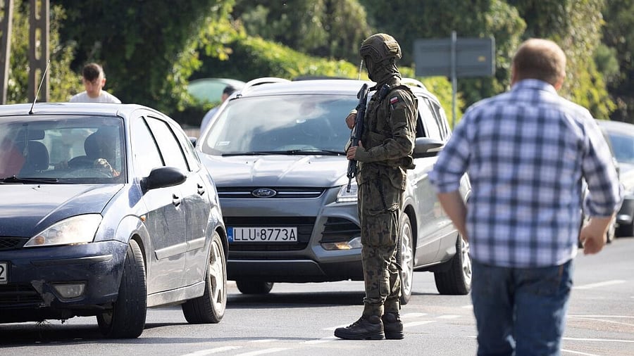 <div class="paragraphs"><p>A soldier stands next to vehicles as they patrol the street after a drone or similar object struck a residential building according to local authorities, following violations of Polish airspace during a Russian attack on Ukraine, in Wyryki municipality, Poland.</p></div>