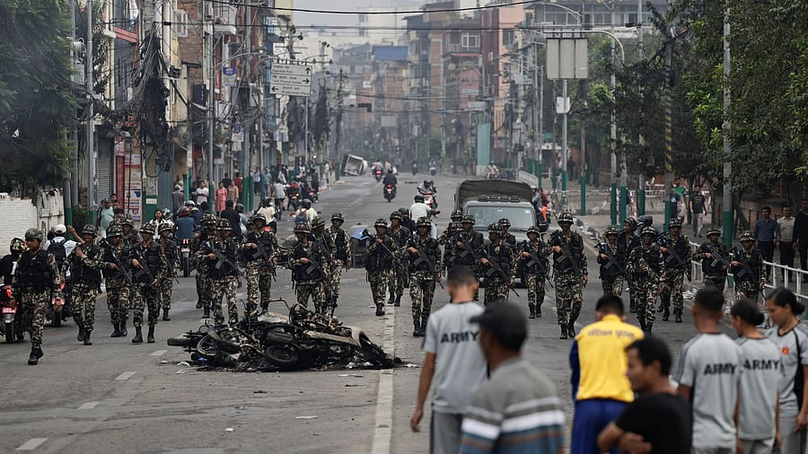 <div class="paragraphs"><p>Nepali army soldiers patrol at the road near the Singha Durbar office complex that houses the Prime Minister's office and other ministries, following protests against Monday's killing of 19 people after anti-corruption protests triggered by a social media ban which was later lifted, in Kathmandu, Nepal, September 10, 2025. </p></div>