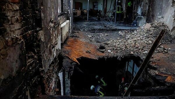 <div class="paragraphs"><p>Rescuers inside a  building damaged  amid Russia's attack on Ukraine, in Kyiv, Ukraine.</p></div>