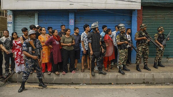 <div class="paragraphs"><p>People look on as security personnel keep vigil in the aftermath of anti-government protests, in Kathmandu, Nepal. (Representative image)</p></div>
