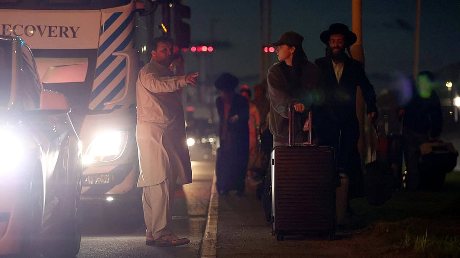 <div class="paragraphs"><p>Passengers walk back to the reopened terminal after emergency services responded to what they called a "possible hazardous materials incident" at Terminal 4 of Heathrow Airport, in Hounslow, London, Britain.</p></div>