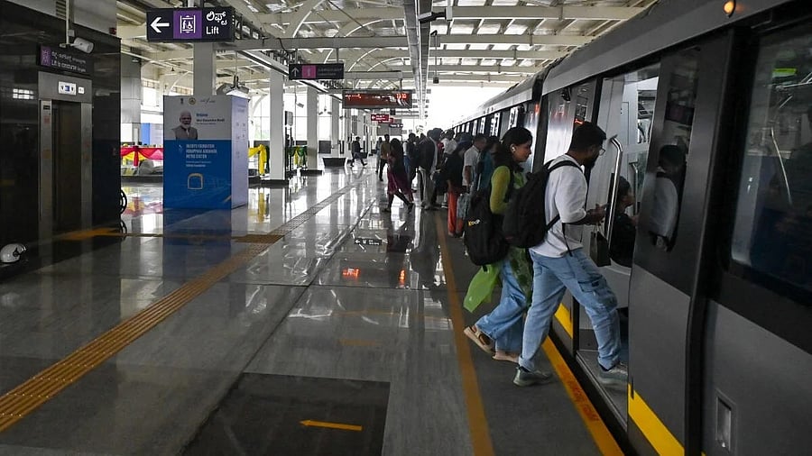 <div class="paragraphs"><p>Commuters entering a metro train at Konappana Agrahara metro station in Bengaluru.</p></div>