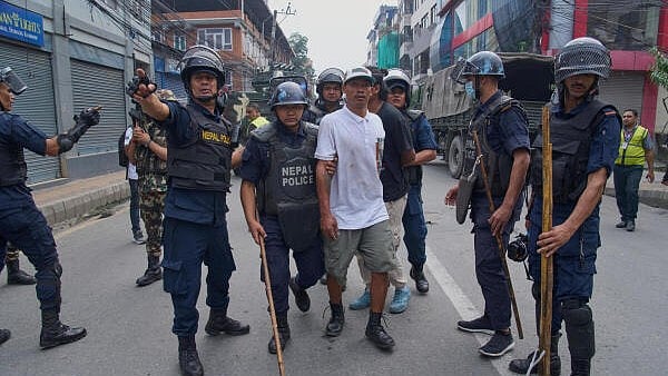 <div class="paragraphs"><p>Policemen arrest a prisoner who escaped from Dilli Bazaar jail in Kathmandu</p></div>