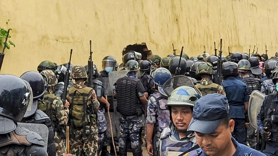 <div class="paragraphs"><p>Security personnel gather to stop prisoners after they attempted to escape by breaching the wall amid anti-government protests, in Nepal.</p></div>