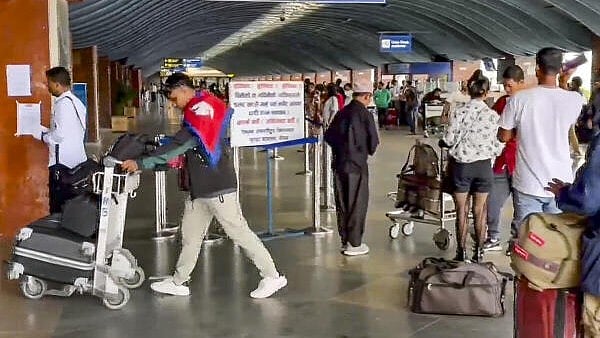 <div class="paragraphs"><p>People with their luggage at the Kathmandu airport as it was reopened.</p></div>