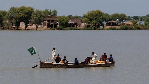 <div class="paragraphs"><p>Residents travel on a boat with their supplies, through a flooded area in Pakistan.</p></div>