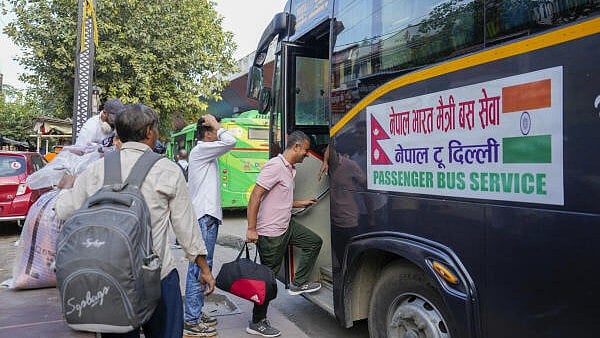 <div class="paragraphs"><p>Nepali nationals board a bus operated by a Nepal-based travel agency as they leave for their home country.</p></div>