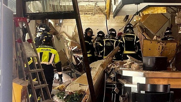 <div class="paragraphs"><p>Firefighters work at the site after an explosion in a cafe.</p></div>