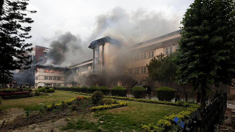<div class="paragraphs"><p>Smoke rising from Nepal's Supreme Court after it was set on fire by demonstrators during an anti-corruption protest in Kathmandu.<br></p></div>