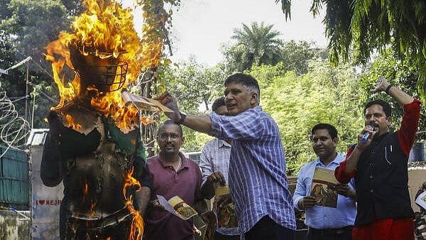 <div class="paragraphs"><p>AAP leader Saurabh Bharadwaj burns an effigy during a protest against the upcoming Asia Cup cricket match between India and Pakistan, at the party office in New Delhi.</p></div>