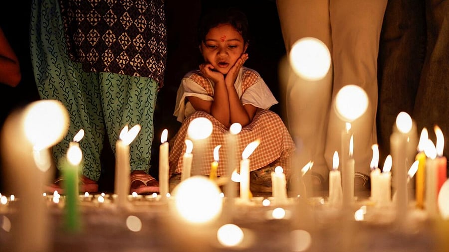<div class="paragraphs"><p>A girl looks on as she takes part in a candlelight vigil in memory of people who died during the protest against anti-corruption triggered by a social media ban, which was later lifted, in Kathmandu, Nepal.</p></div>