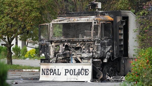 <div class="paragraphs"><p>A charred vehicle with a placard 'Nepal Police' written on it, inside the Parliament premises in the wake of the anti-government protests, in Kathmandu, Nepal.</p></div>