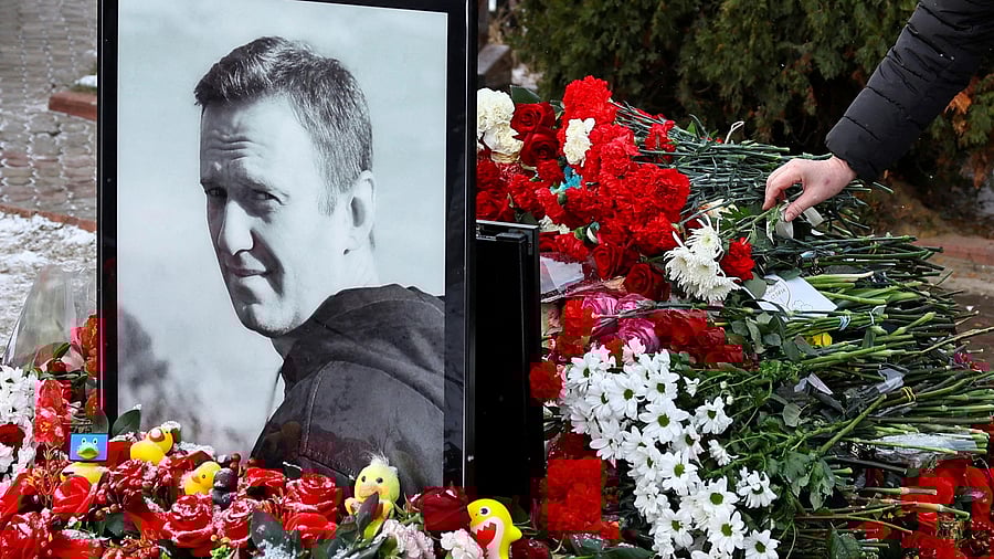 <div class="paragraphs"><p>A person lays flowers at the grave of Russian opposition leader Alexei Navalny while marking the first anniversary of his death at a cemetery in Moscow, Russia.</p></div>