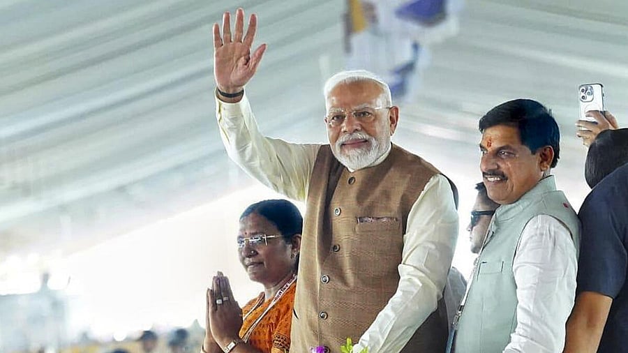 <div class="paragraphs"><p>Prime Minister Narendra Modi greets the public on his arrival to lay the foundation stone of the PM Mitra Park, at Bhensola village in Badnawar tehsil of Dhar district, in Madhya Pradesh.</p></div>
