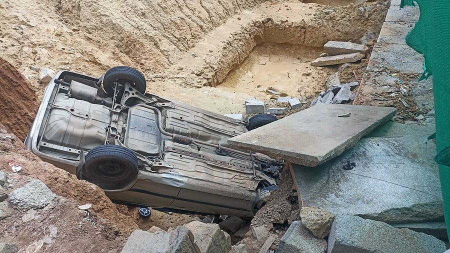 <div class="paragraphs"><p>A car, with four passengers, fell into a 12ft ditch on the Gandhi Bazaar Main Road on Wednesday morning. The driver and passengers sustained no major injuries.</p></div>