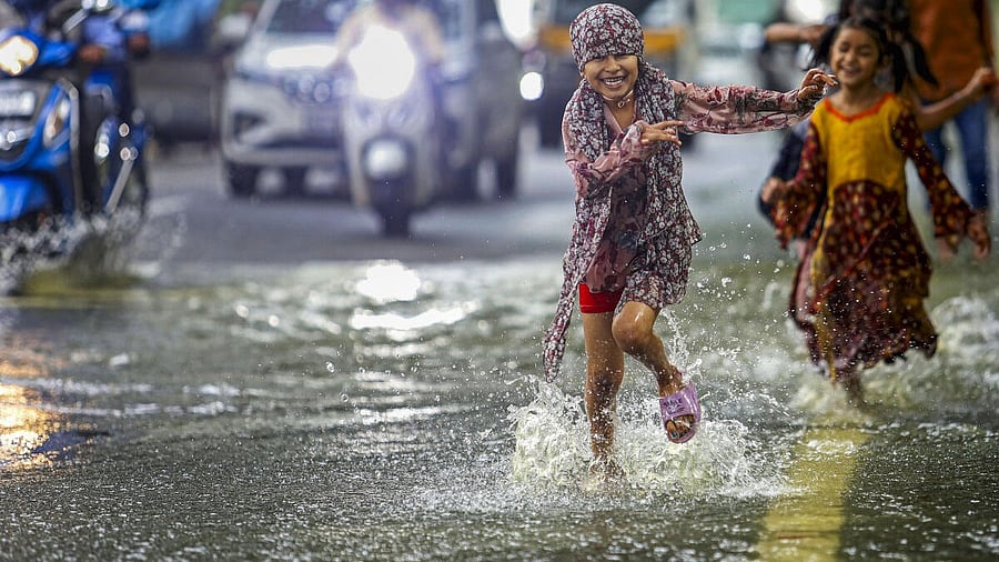 <div class="paragraphs"><p>Children play on a waterlogged road after heavy rain, in Bengaluru.</p></div>