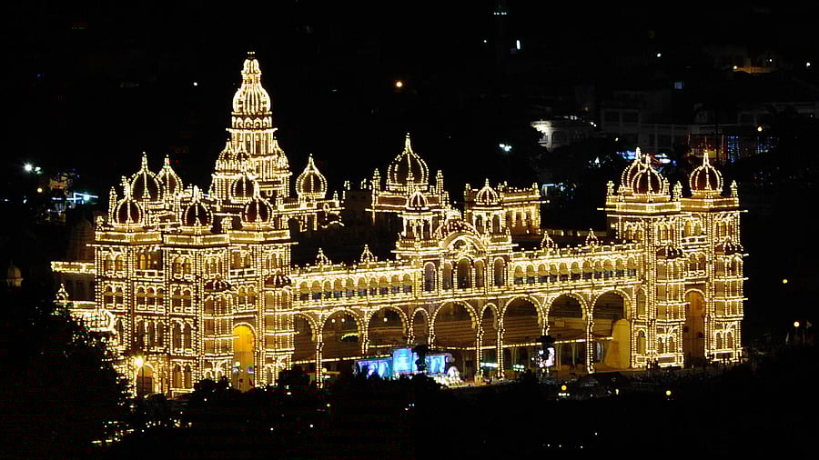 A bird’s eye view of the illuminated Mysuru Palace from Chamundi Hills. PICS FROM DH ARCHIVES