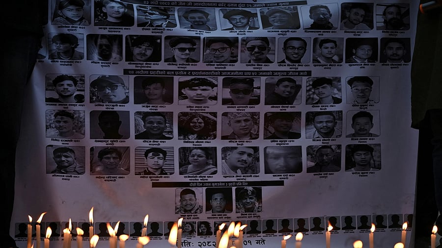 <div class="paragraphs"><p>Candles burn next to a banner with images of people who died during the recent anti-corruption protests that toppled the Nepalese government, at a candlelight vigil in front of the parliament building.</p></div>
