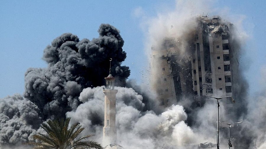 <div class="paragraphs"><p>Smoke rises as the 15-storey Mushtaha Tower collapses after being hit by an Israeli air strike, in Gaza City.</p></div>