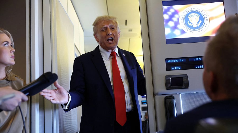 <div class="paragraphs"><p>US President Donald Trump speaks to reporters aboard Air Force One on his return from a state visit in Britain.</p></div>