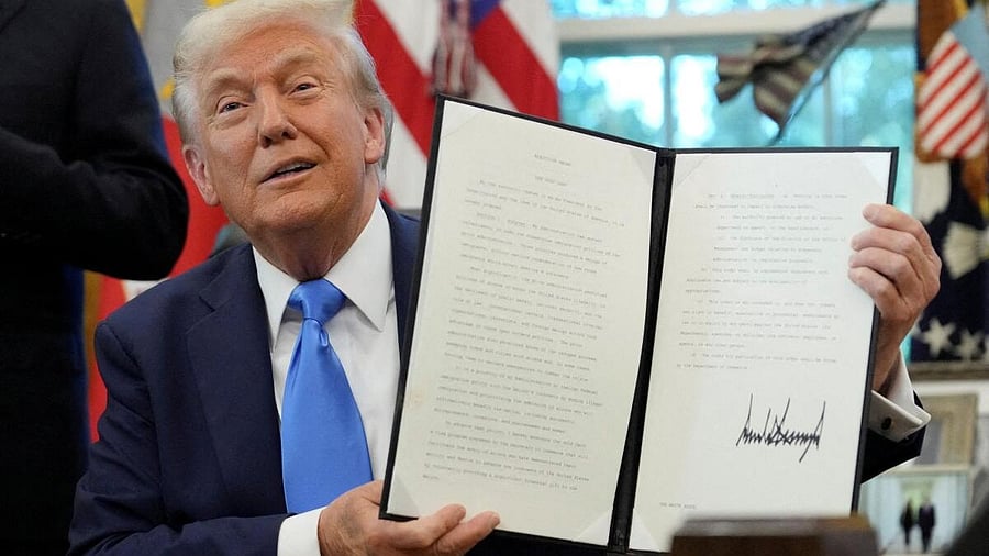 <div class="paragraphs"><p>US President Donald Trump displays a signed executive order.</p></div>