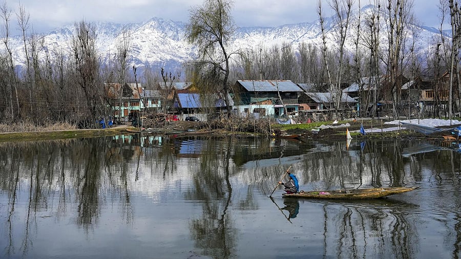<div class="paragraphs"><p>A woman rows her boat across Dal Lake  in Srinagar.</p></div>