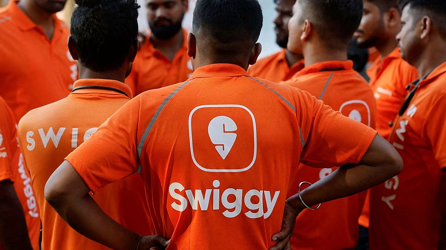 <div class="paragraphs"><p>Swiggy gig workers listen to a briefing during a promotional event in Mumbai.</p></div>