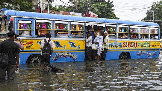 <div class="paragraphs"><p>An overcrowded bus moves through a waterlogged road following rain, in Kolkata.</p></div>
