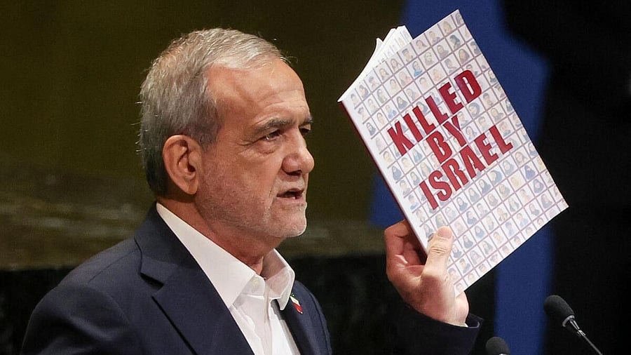 <div class="paragraphs"><p>Iran's President Masoud Pezeshkian holds up a book as he addresses the 80th United Nations General Assembly (UNGA) at the U.N. headquarters in New York, US.</p></div>