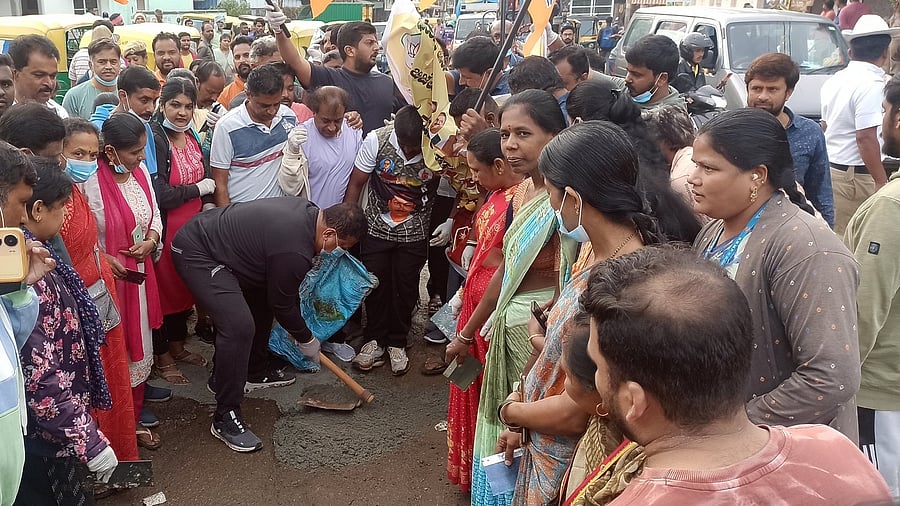<div class="paragraphs"><p>BJP workers and leaders filling a pothole in Bengaluru as part of a protest on Wednesday.&nbsp;</p></div>