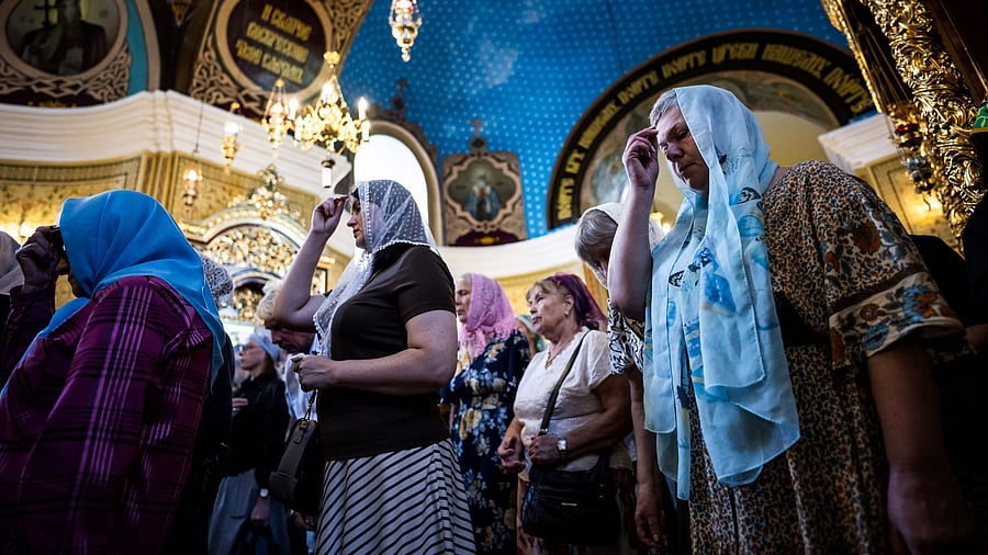 <div class="paragraphs"><p>Women pray in a church during Mass in Chisinau</p></div>