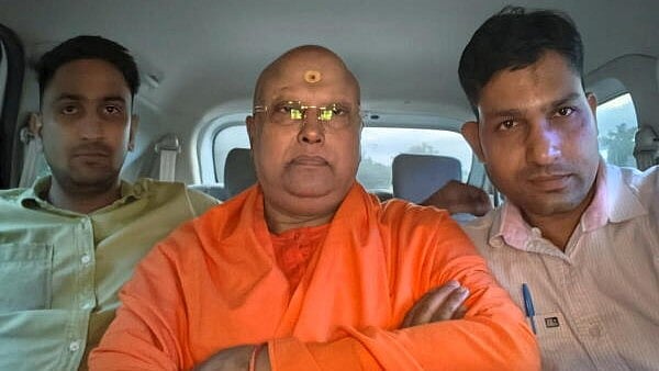 <div class="paragraphs"><p>Self-styled godman Chaitanyananda Saraswati, center, who allegedly sexually harassed 17 women students at a private institute, with police personnel after his arrest, in Agra, Uttar Pradesh.</p></div>