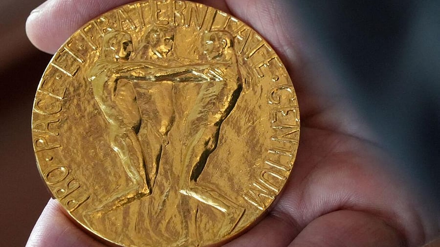 <div class="paragraphs"><p>An employee of the Norwegian Nobel Institute holds a replica of a Nobel Peace Medal in the Institute in Oslo, Norway.</p></div>