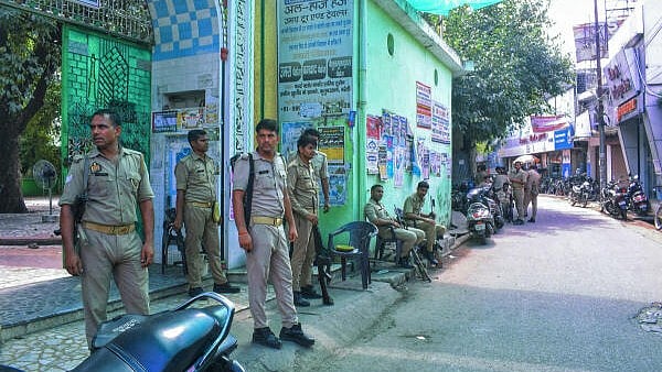 <div class="paragraphs"><p>Police personnel stand guard outside a dargah, a day after clashes between police and locals, in Bareilly, Uttar Pradesh.</p></div>