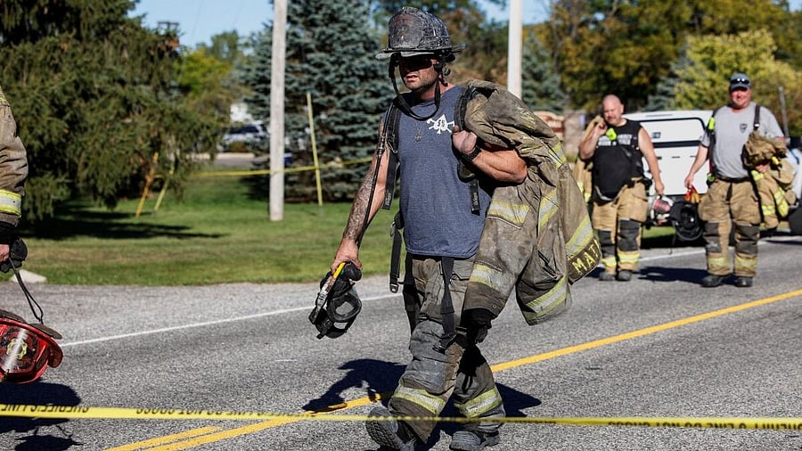 <div class="paragraphs"><p>Firefighters walk away from the scene of a shooting at the Church of Jesus Christ of Latter-day Saints, in Grand Blanc, Michigan, U.S., September 28, 2025.</p></div>