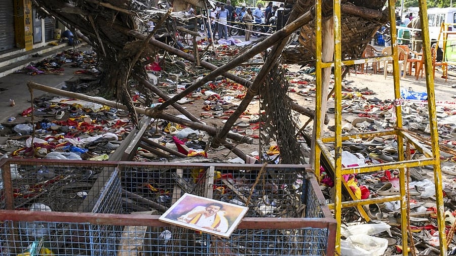 <div class="paragraphs"><p>A portrait of Vijay lies on a metal fencing after the stampede.&nbsp;</p></div>